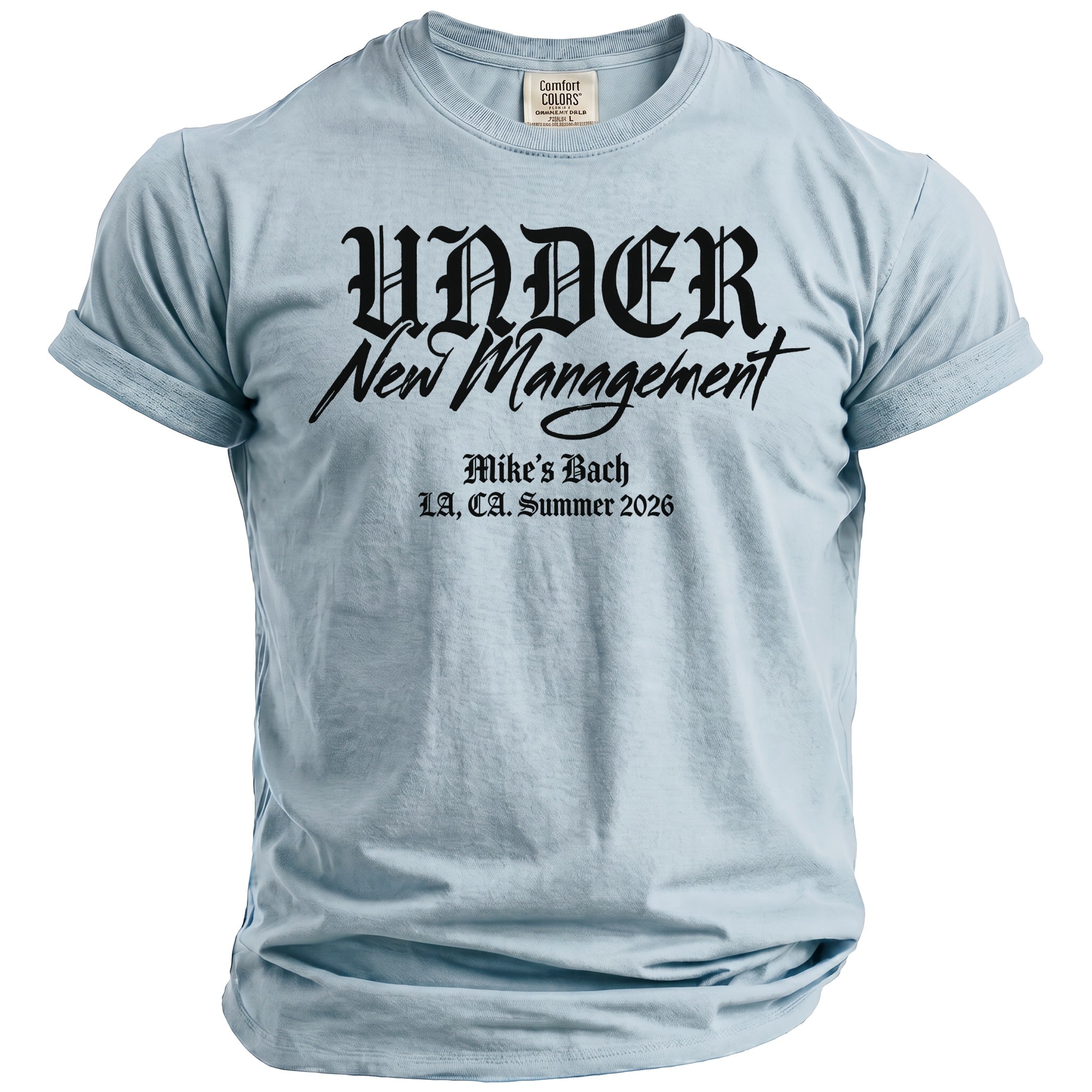 Light blue t-shirt with black text: "UNDER New Management, Mike's Bach, L.A., CA. Summer 2026".