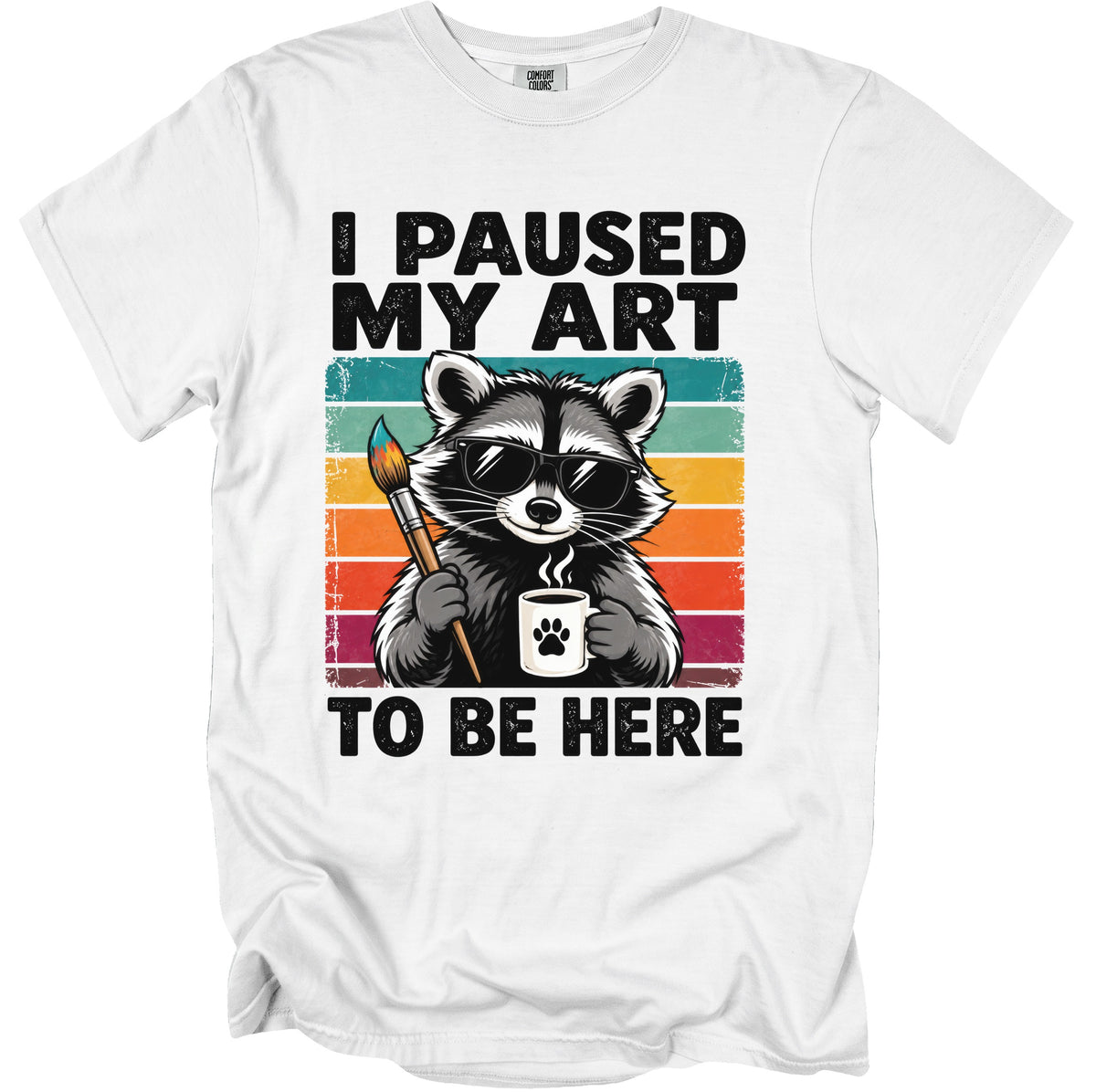 White t-shirt with a raccoon wearing sunglasses holding a paintbrush and coffee mug.