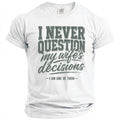 White t-shirt with "I NEVER QUESTION my wife's decisions -I AM ONE OF THEM-" text.
