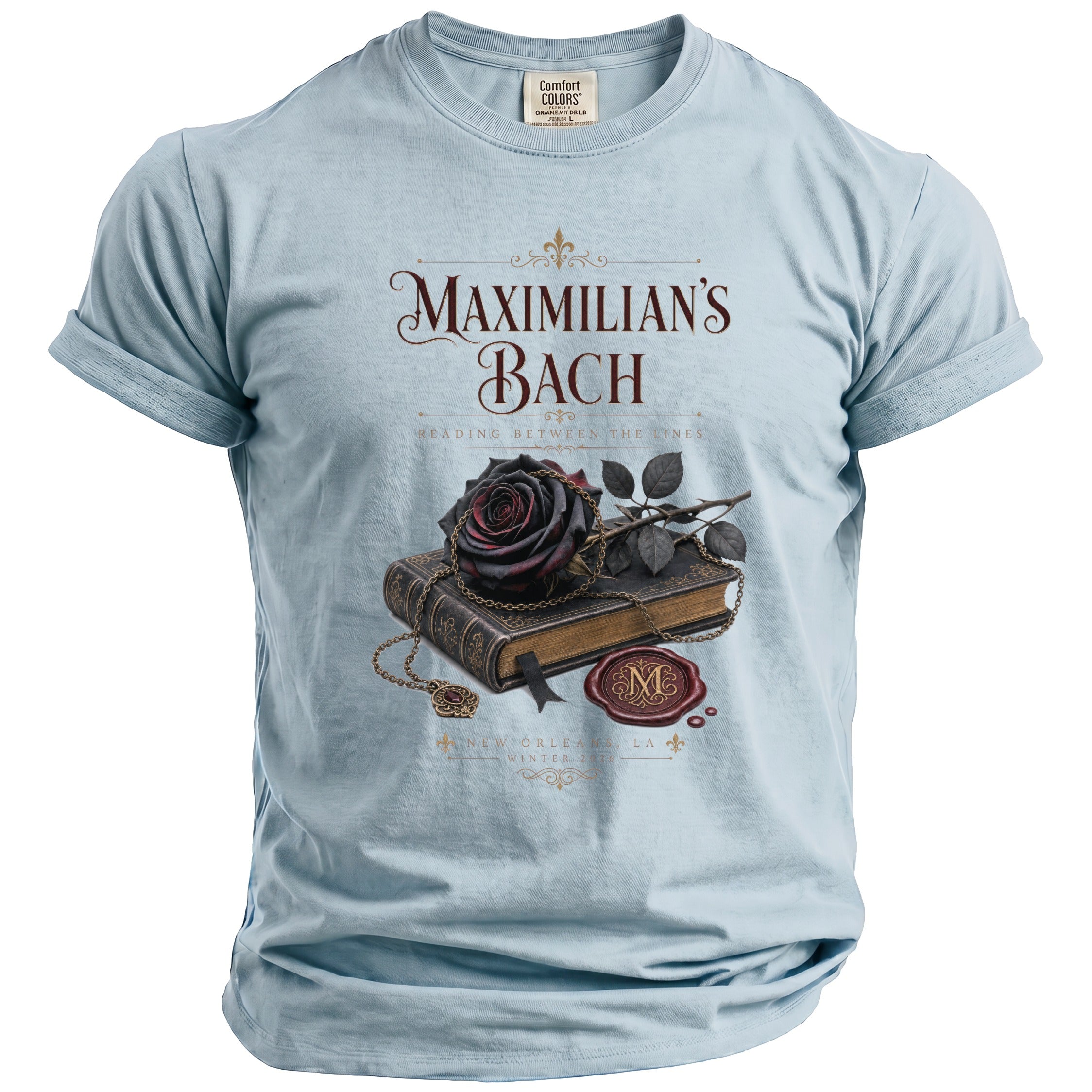 Light blue t-shirt with "Maximilian's Bach" and a dark rose on a book.