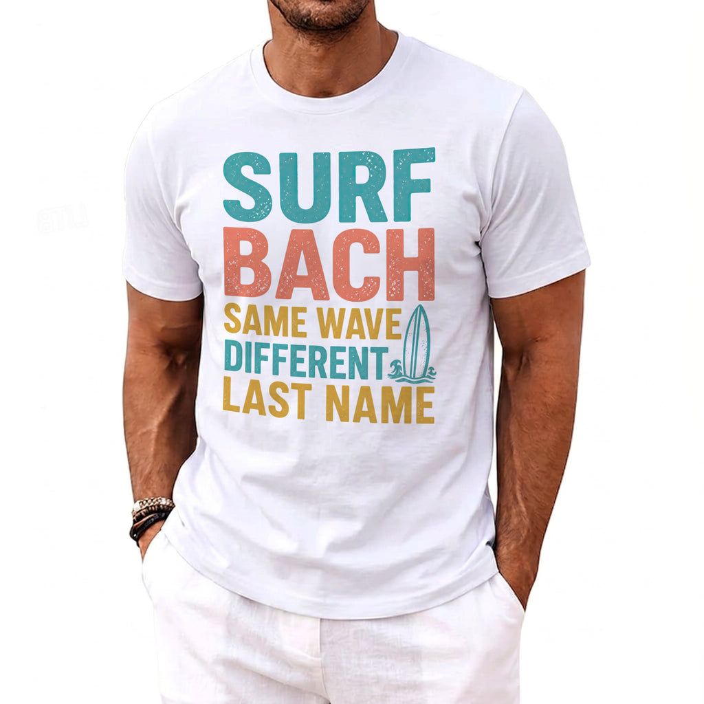 White t-shirt with text "SURF BACH SAME WAVE DIFFERENT LAST NAME" and surfboard graphic.