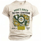 T-shirt with "Mike's Bach The Final Countdown" text, featuring a suit, clock, luggage, and drinks.