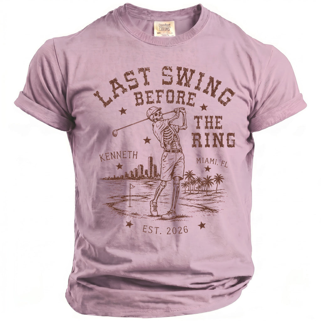 Skeleton golfer graphic on a pink t-shirt with text "Last Swing Before The Ring, Kenneth, Miami, FL, Est. 2026".