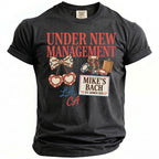 Black t-shirt with "Under New Management" and "Mike's Bach" graphics.