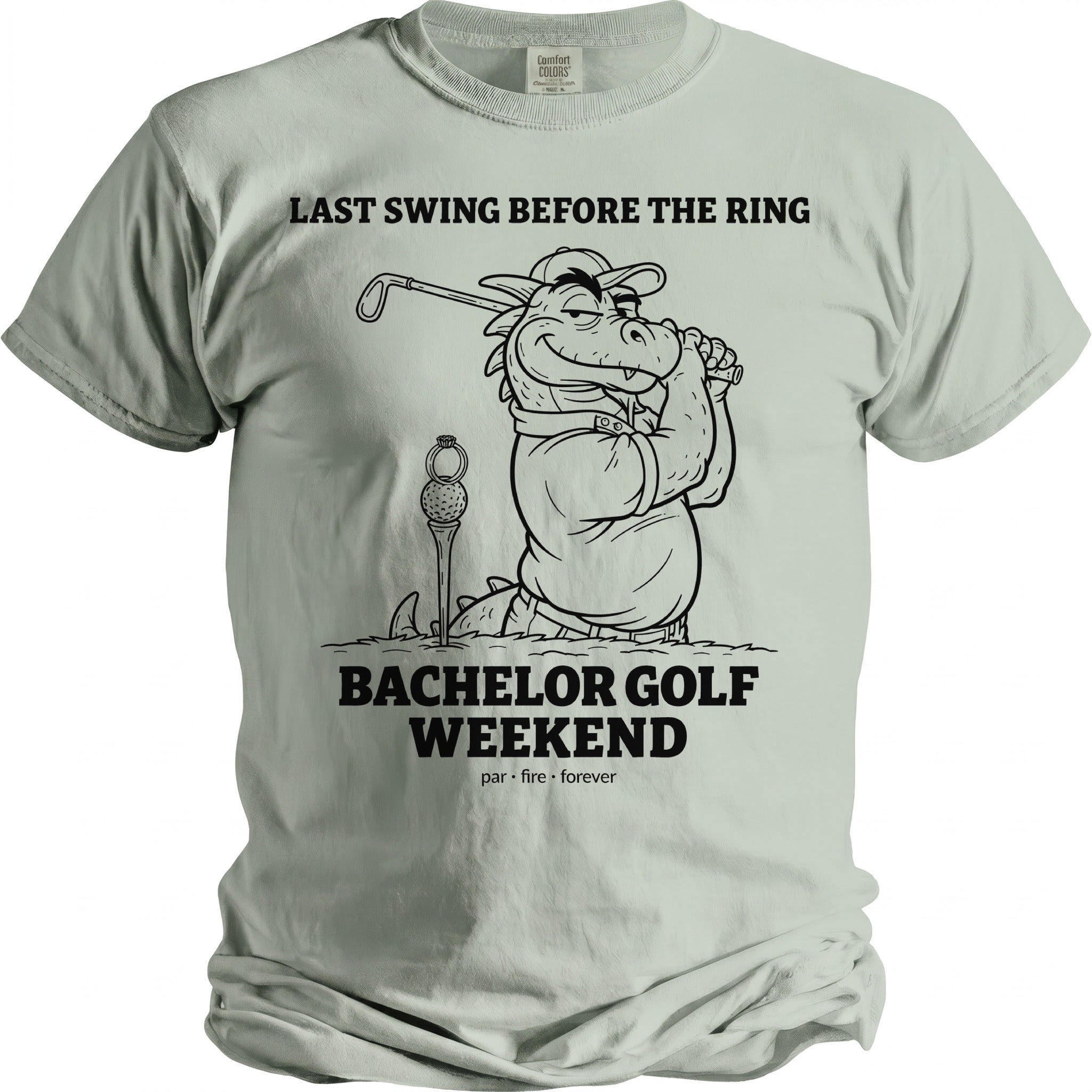 T-shirt graphic with text "Last Swing Before the Ring" and a cartoon dragon golfing.