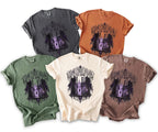 Five t-shirts in different colors display a graphic of ornate gates leading to an eerie manor with the text "Some Curses Follow You Home."