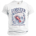 White t-shirt with a lobster wearing sunglasses relaxing on a beach chair. Text reads "LOBSTER Bach" and "Shell yeah, I'm on island time."