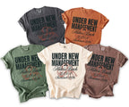 Five t-shirts in various colors featuring "Under New Management Mike's Bach LA, CA Summer 2026" text.