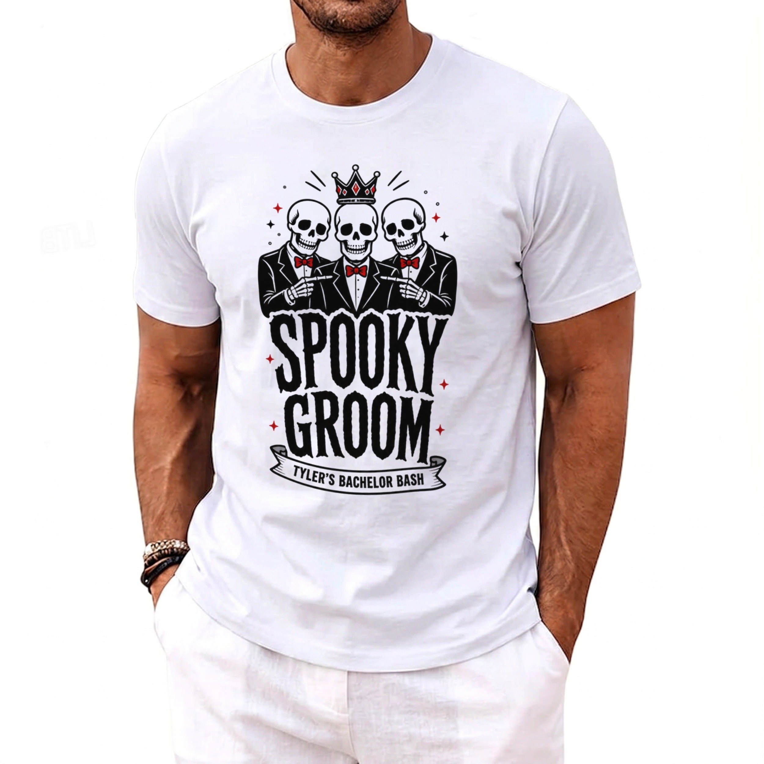 White t-shirt with three skeletons in suits, text "SPOOKY GROOM TYLER'S BACHELOR BASH."