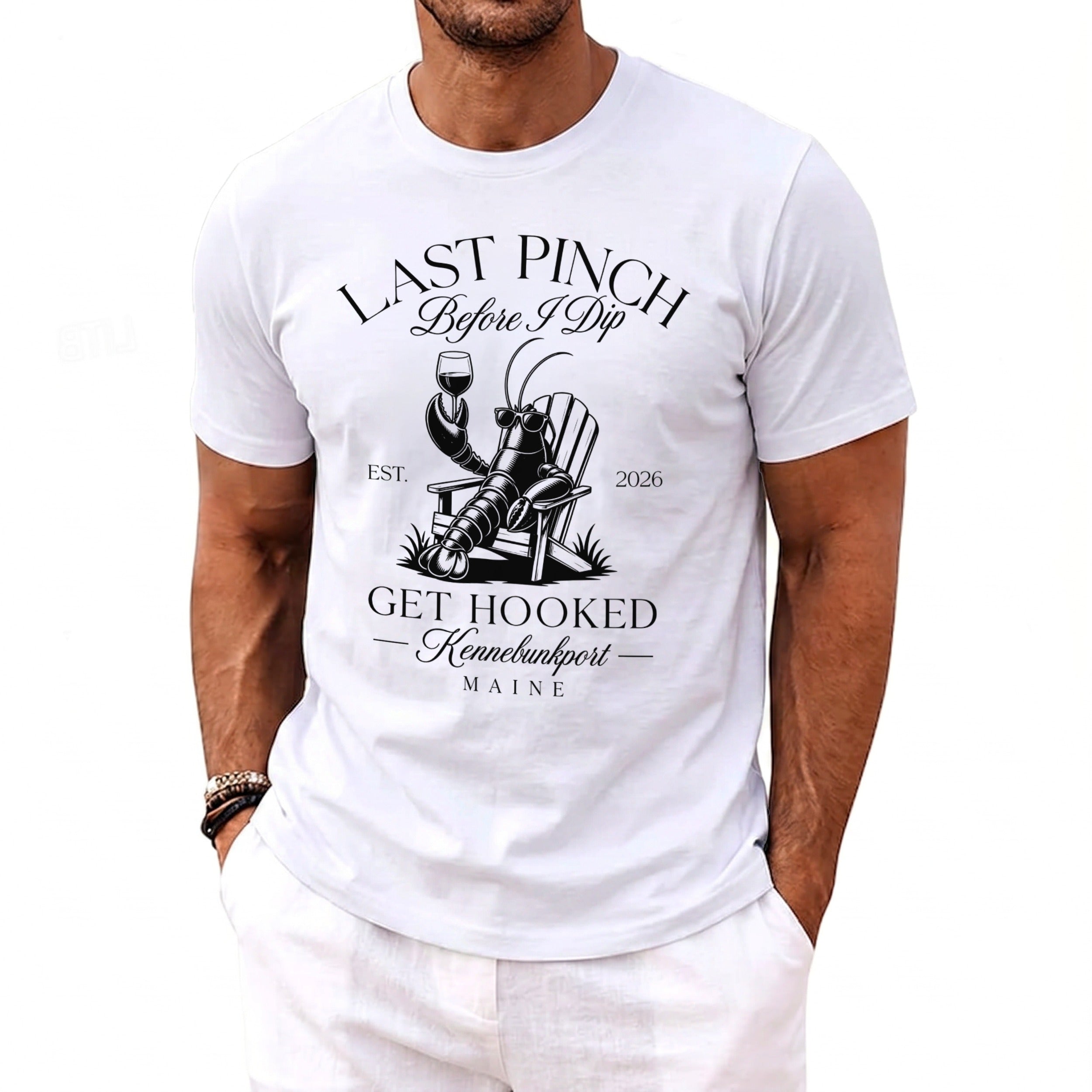 White t-shirt with black graphic: lobster in deck chair, "Last Pinch Before I Dip" text.