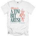 White t-shirt with "Olivia's A Tini Bit Artsy" text, paint palette, and brushes.
