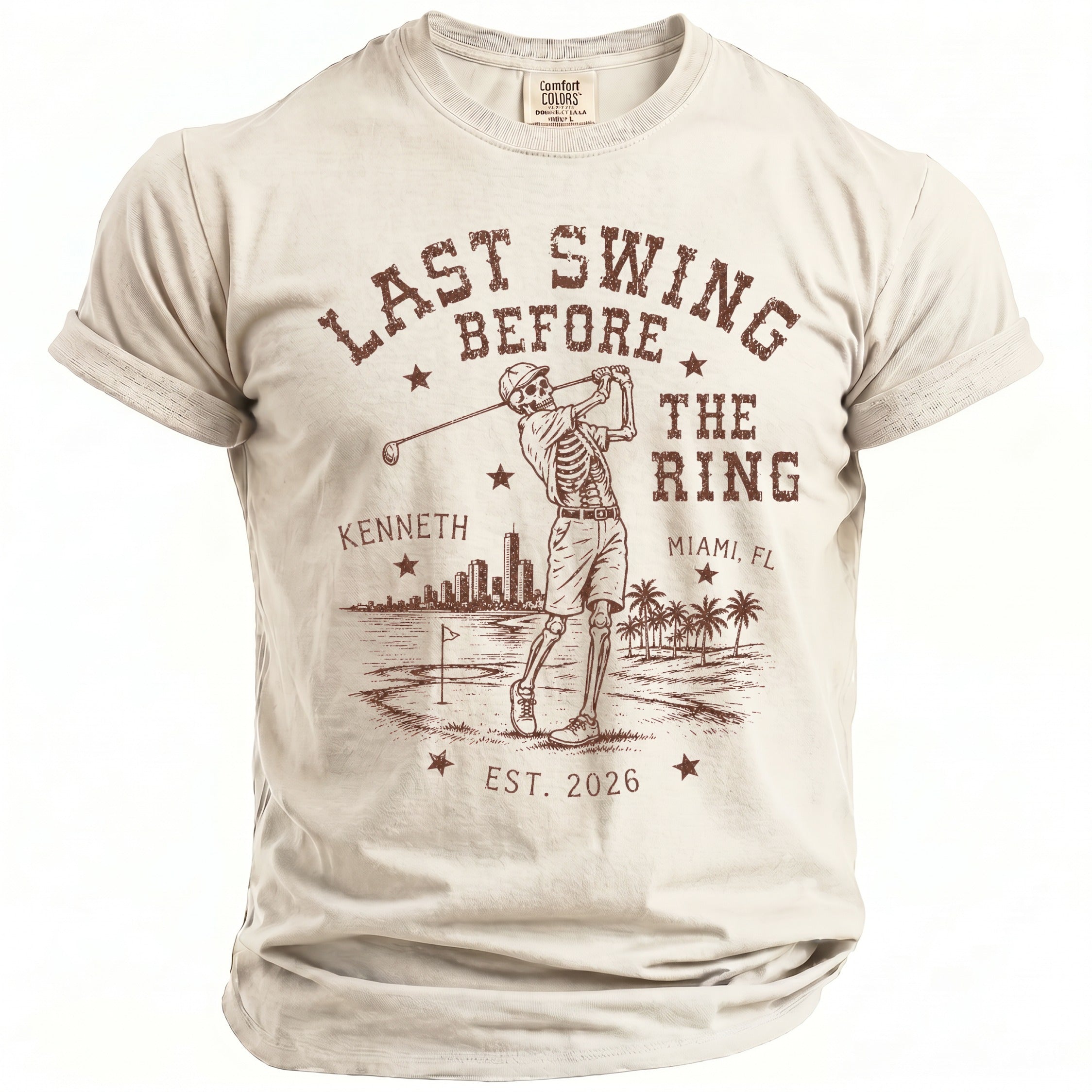 Skeleton golfer graphic on a beige t-shirt with "Last Swing Before The Ring" text.