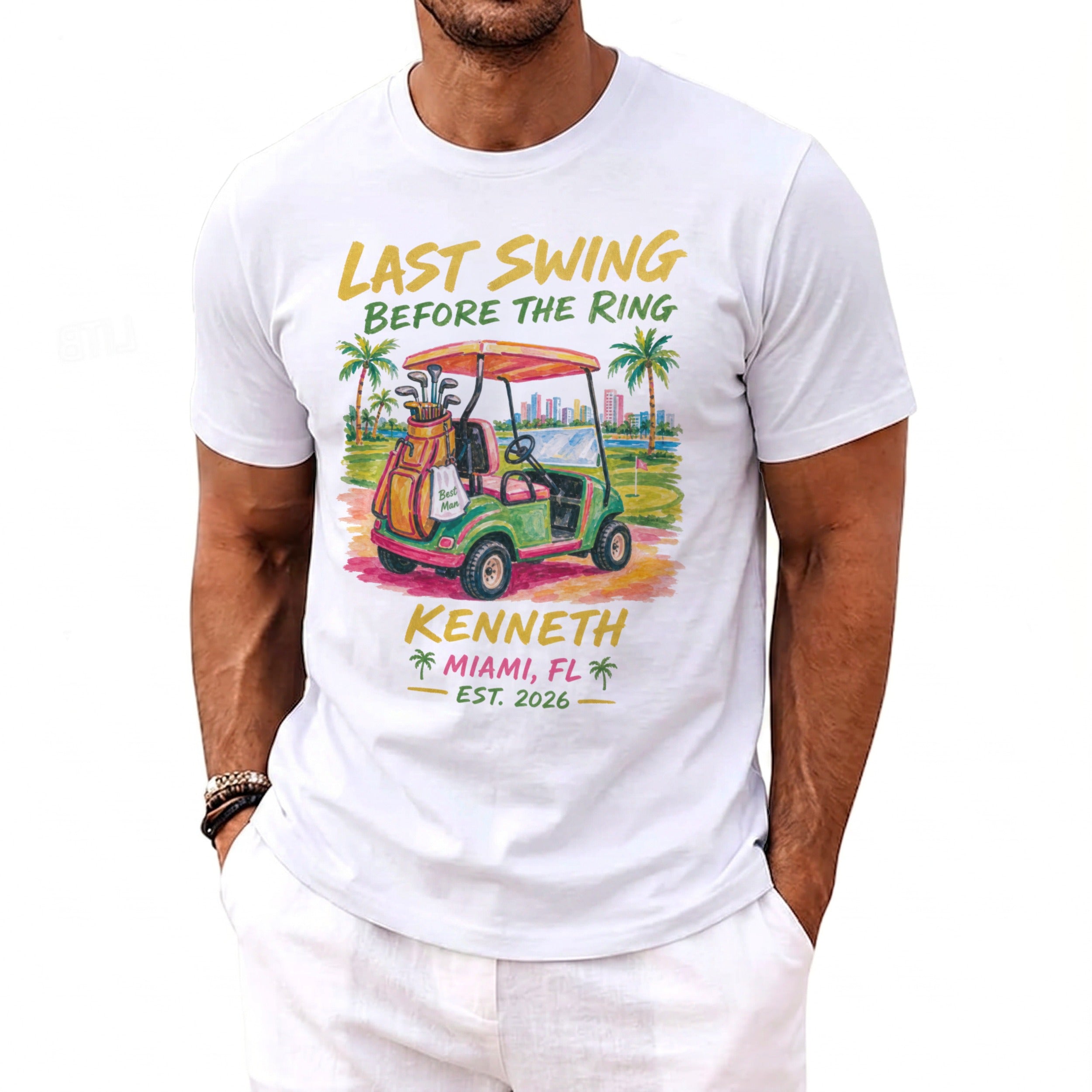 White t-shirt with graphic: "Last Swing Before The Ring," golf cart, and "Kenneth Miami, FL Est. 2026."