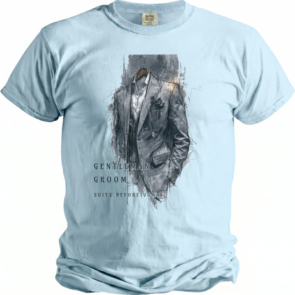 Light blue t-shirt with a sketched grey suit design and text reading "GENTLEMAN GROOM SUITS BEFORE VOWS".