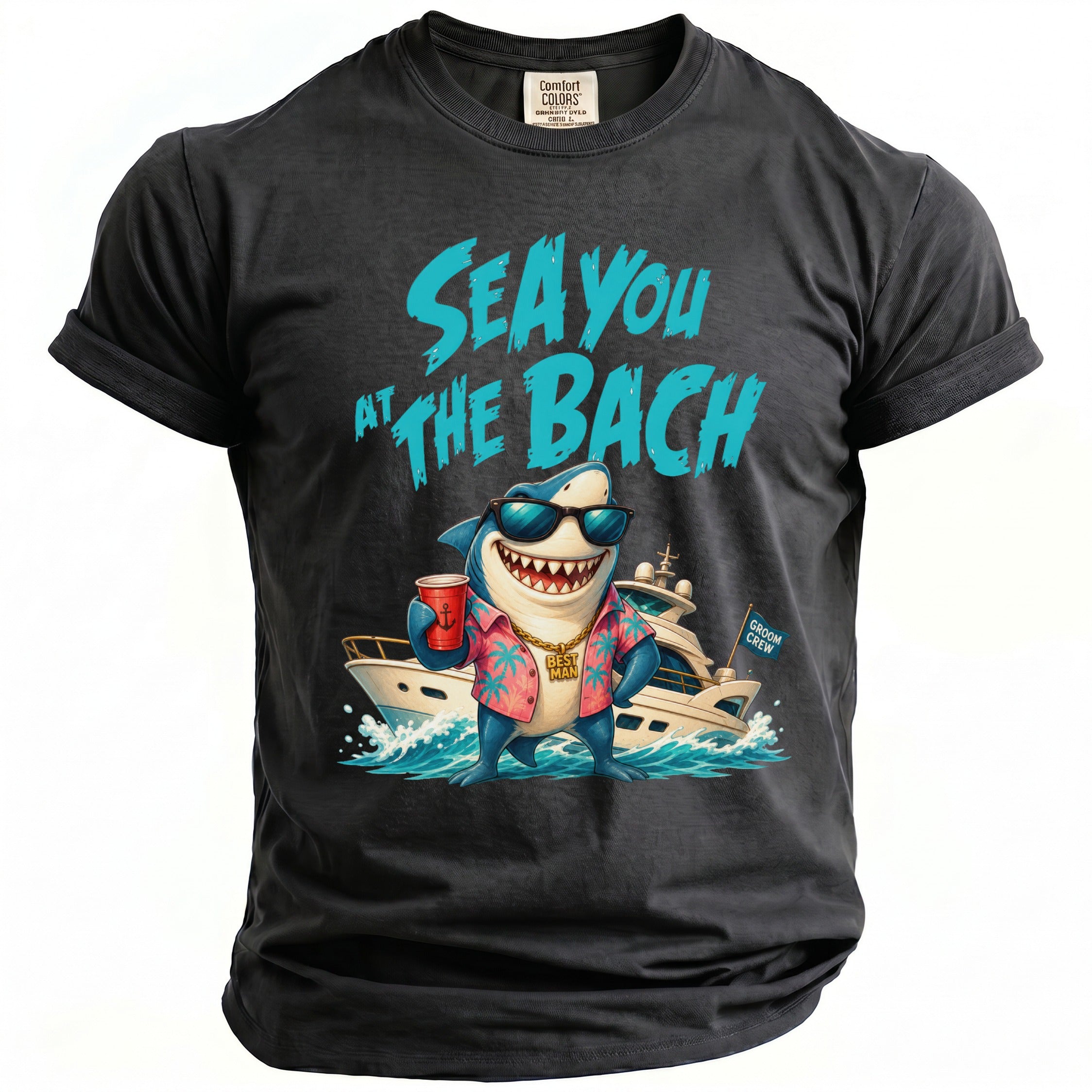 A dark gray t-shirt with a cartoon shark in a Hawaiian shirt, holding a red cup, and text that reads Sea You At The Bach.