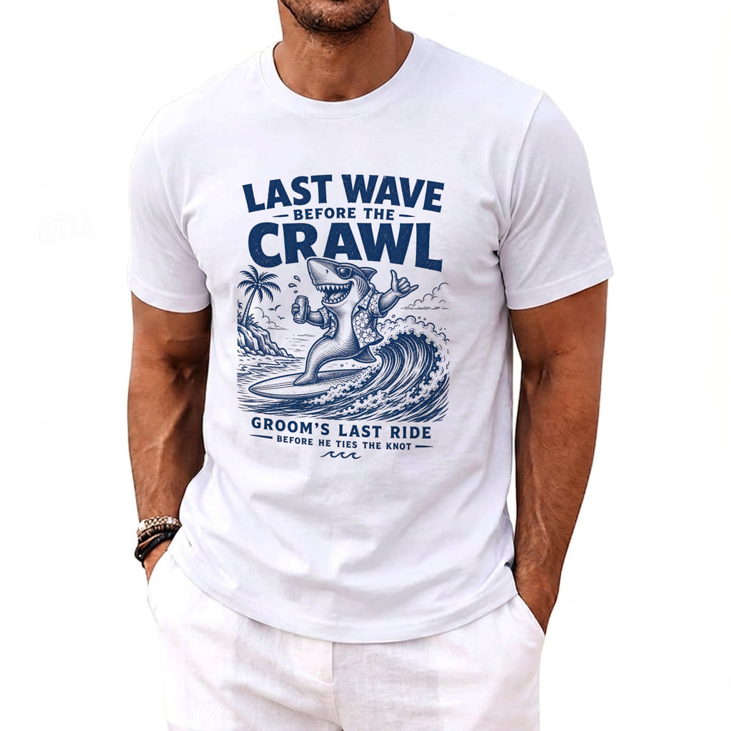 White t-shirt with blue graphic of a surfing shark and text "Last Wave Before the Crawl Groom's Last Ride".