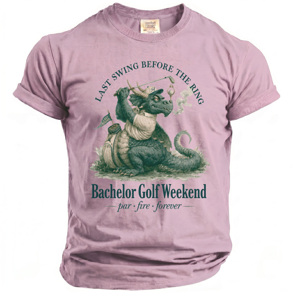 Pink t-shirt with a dragon golfer graphic and text "Bachelor Golf Weekend".