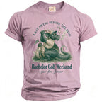 Pink t-shirt with a dragon golfer graphic and text "Bachelor Golf Weekend".