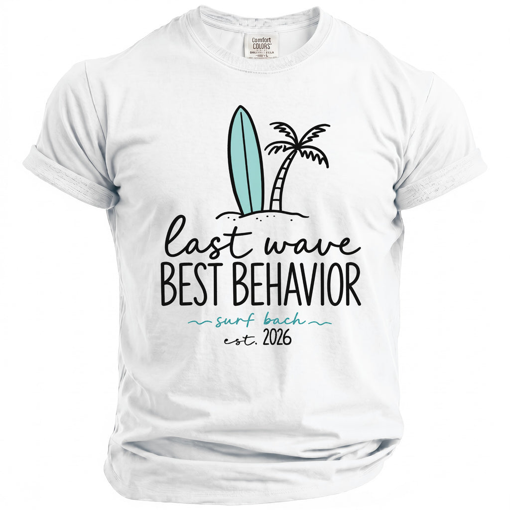 White t-shirt with surfboard, palm tree, and text "last wave BEST BEHAVIOR surf bach est. 2026".