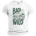 White t-shirt with green text and camping graphic: "Bach in the Wild".