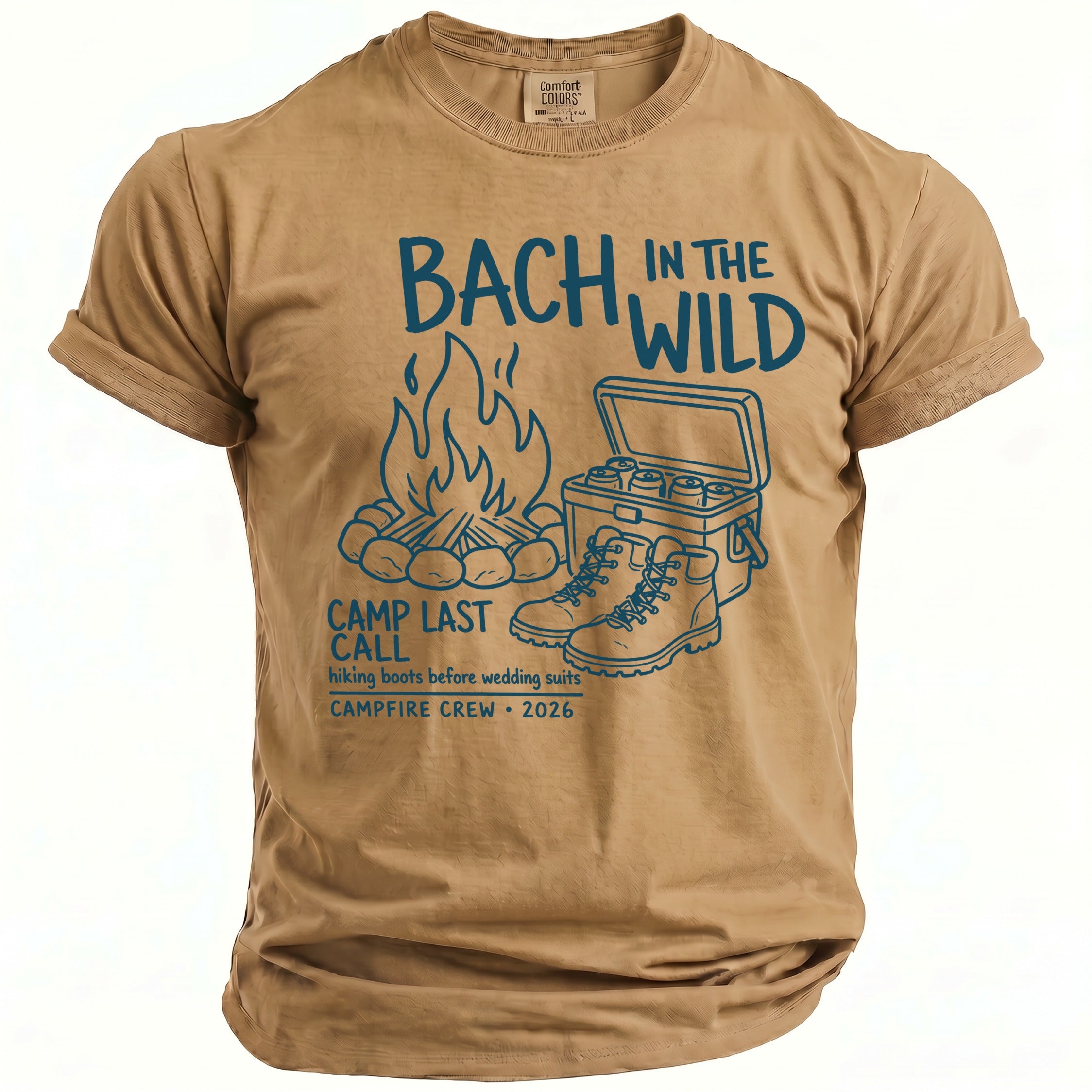 Tan t-shirt with blue graphic: campfire, cooler, boots, and text "Bach In The Wild Camp Last Call".