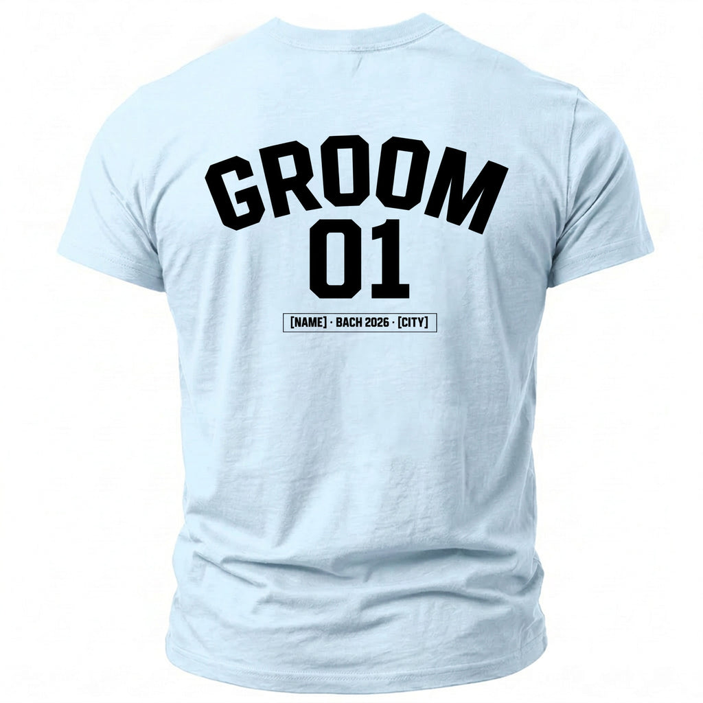 Light blue t-shirt with "GROOM 01" and "[NAME] - BACH 2026 - [CITY]" printed on back.