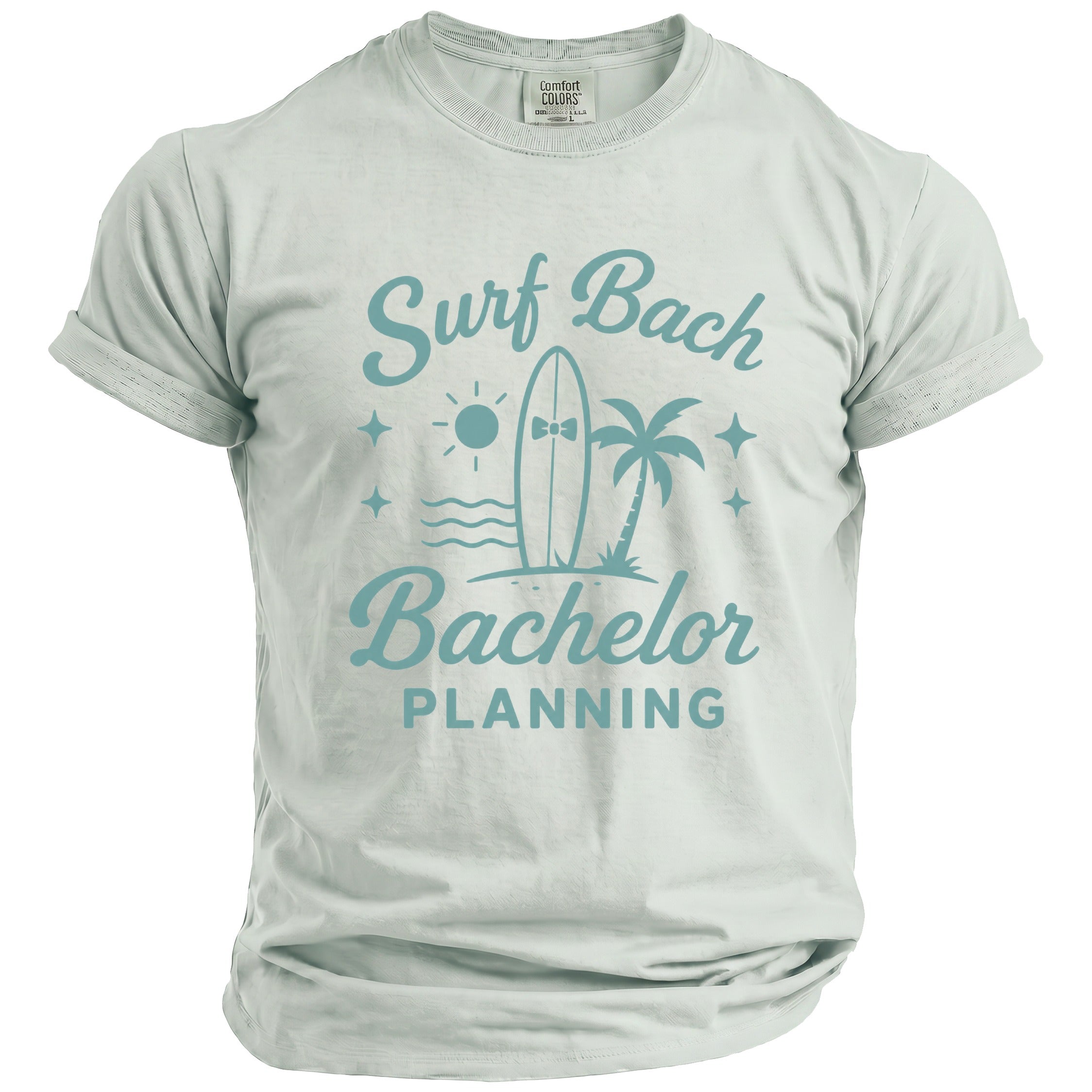 Light blue t-shirt with "Surf Bachelor Planning" graphic of surfboard, palm tree, and sun.