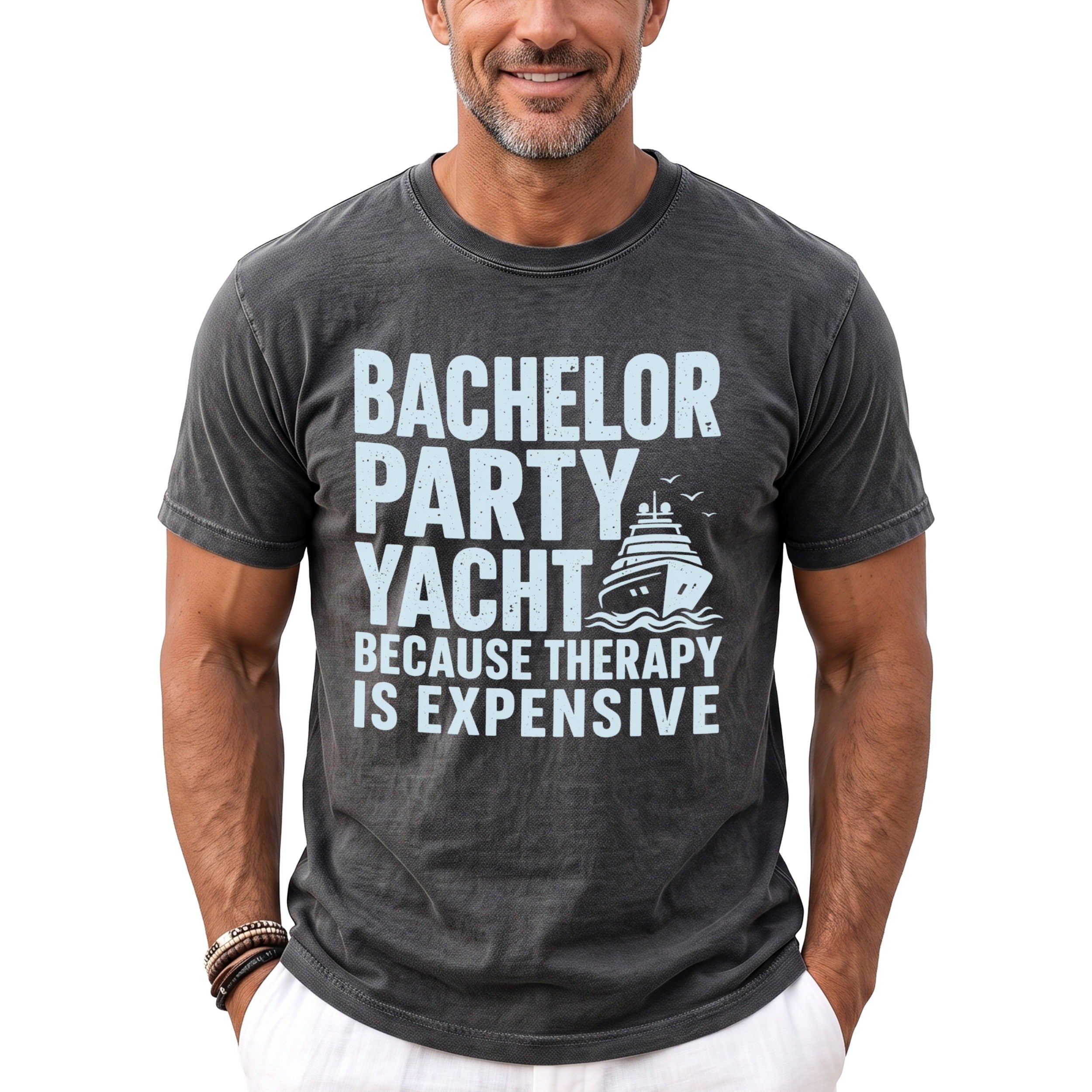 Dark gray t-shirt with light blue text "BACHELOR PARTY YACHT BECAUSE THERAPY IS EXPENSIVE" and a yacht graphic.