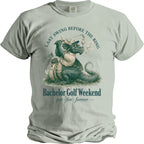 T-shirt graphic of a dragon playing golf with text "LAST SWING BEFORE THE RING".
