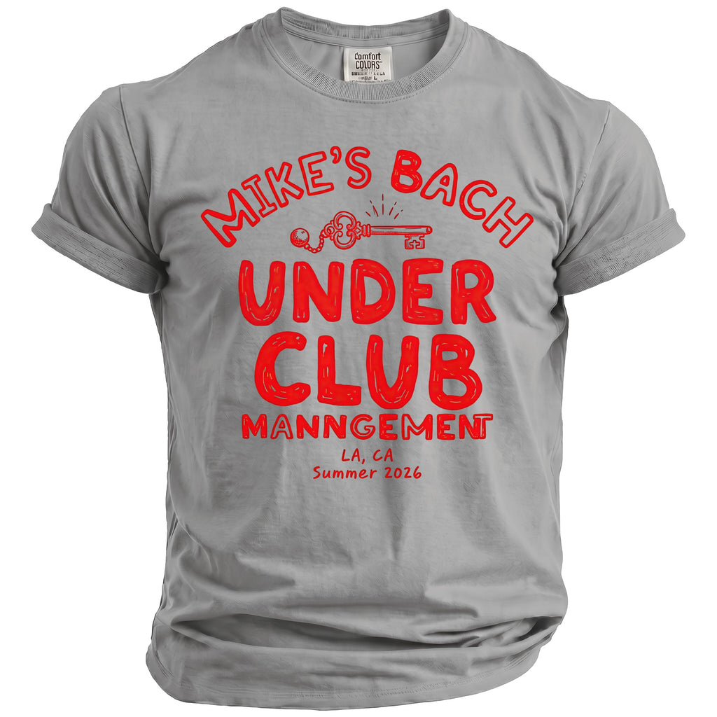 Grey t-shirt with red text "MIKE'S BACH UNDER CLUB MANNGEMENT LA, CA Summer 2026" and a key graphic.