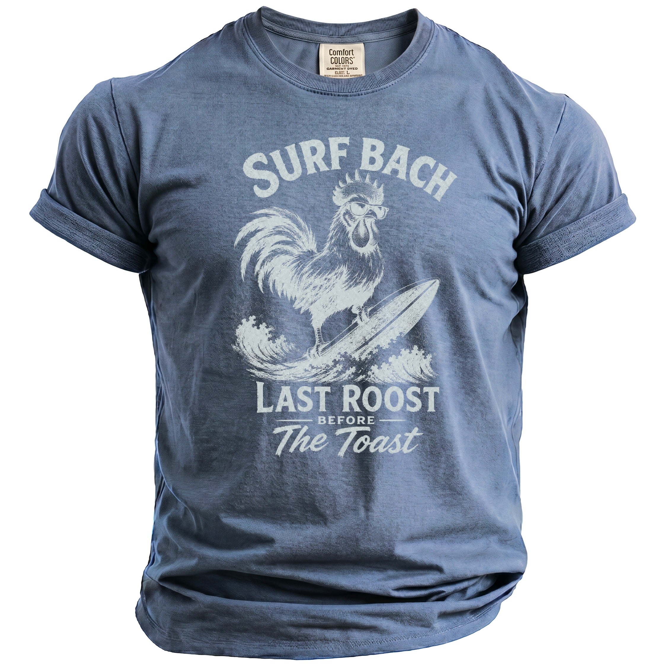 Blue t-shirt with white graphic of a rooster surfing with text "Surf Bach Last Roost Before The Toast".