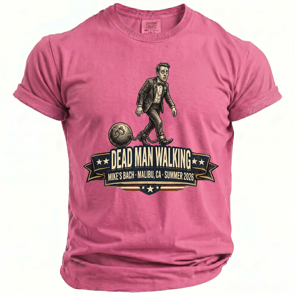 Pink t-shirt featuring a man in a suit chained to a ball, with "Dead Man Walking" text.