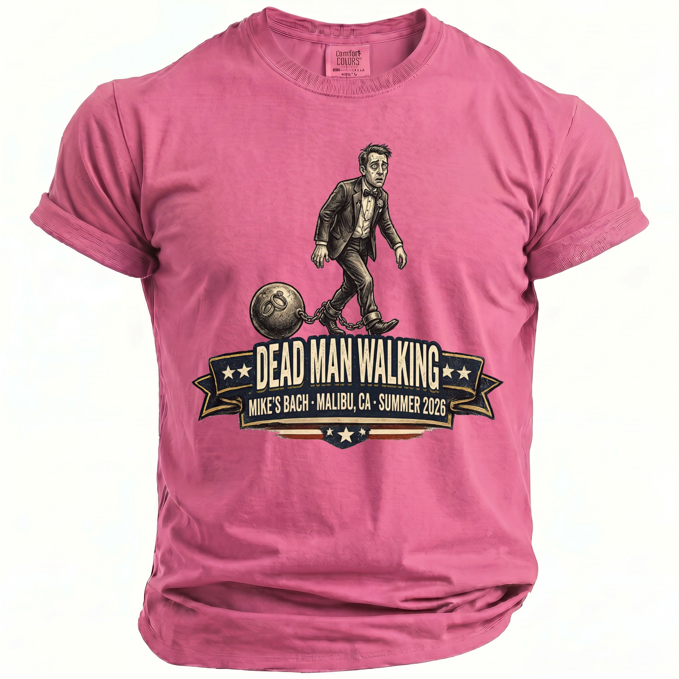 Pink t-shirt featuring a man in a suit chained to a ball, with "Dead Man Walking" text.