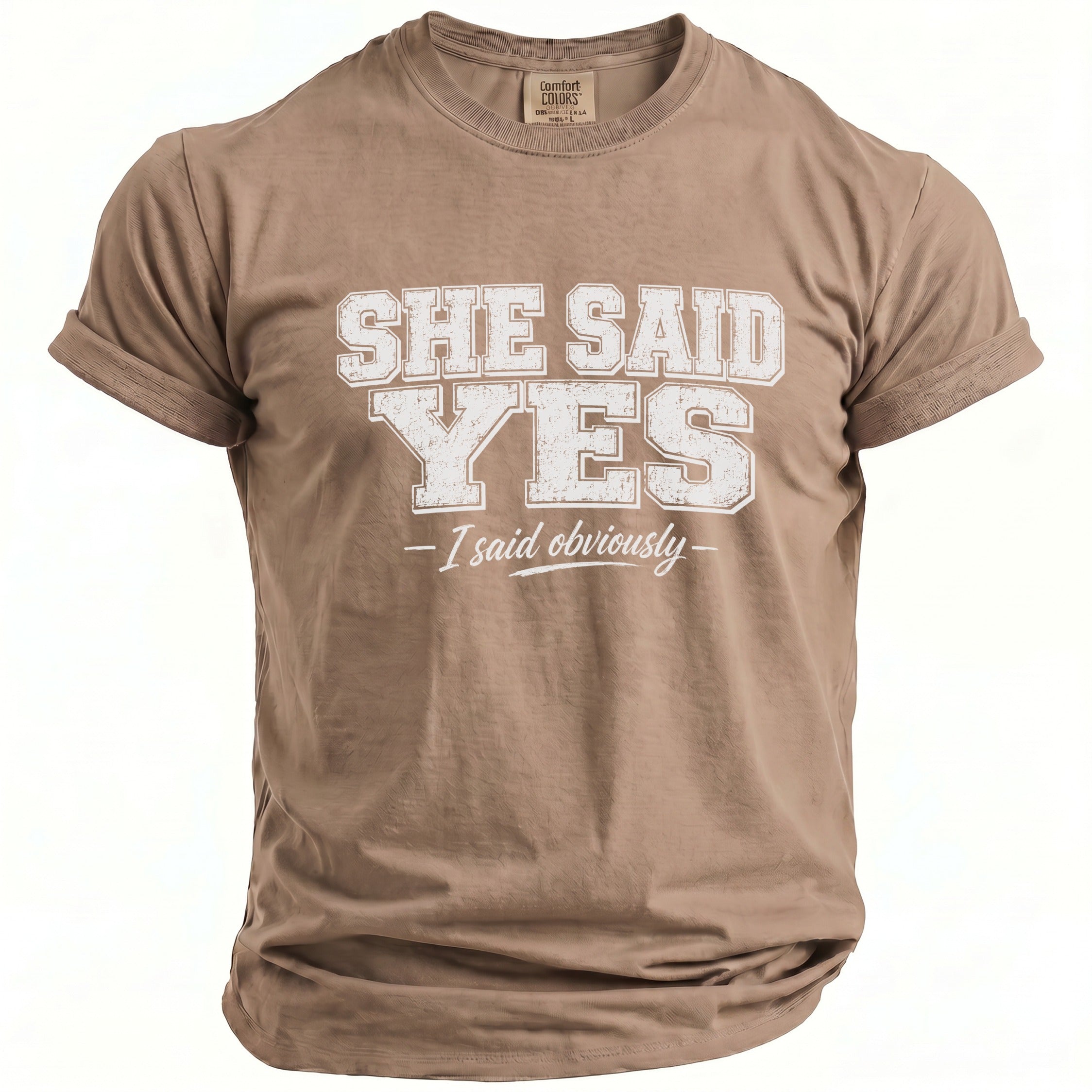 Brown t-shirt with "SHE SAID YES - I said obviously" printed in white.