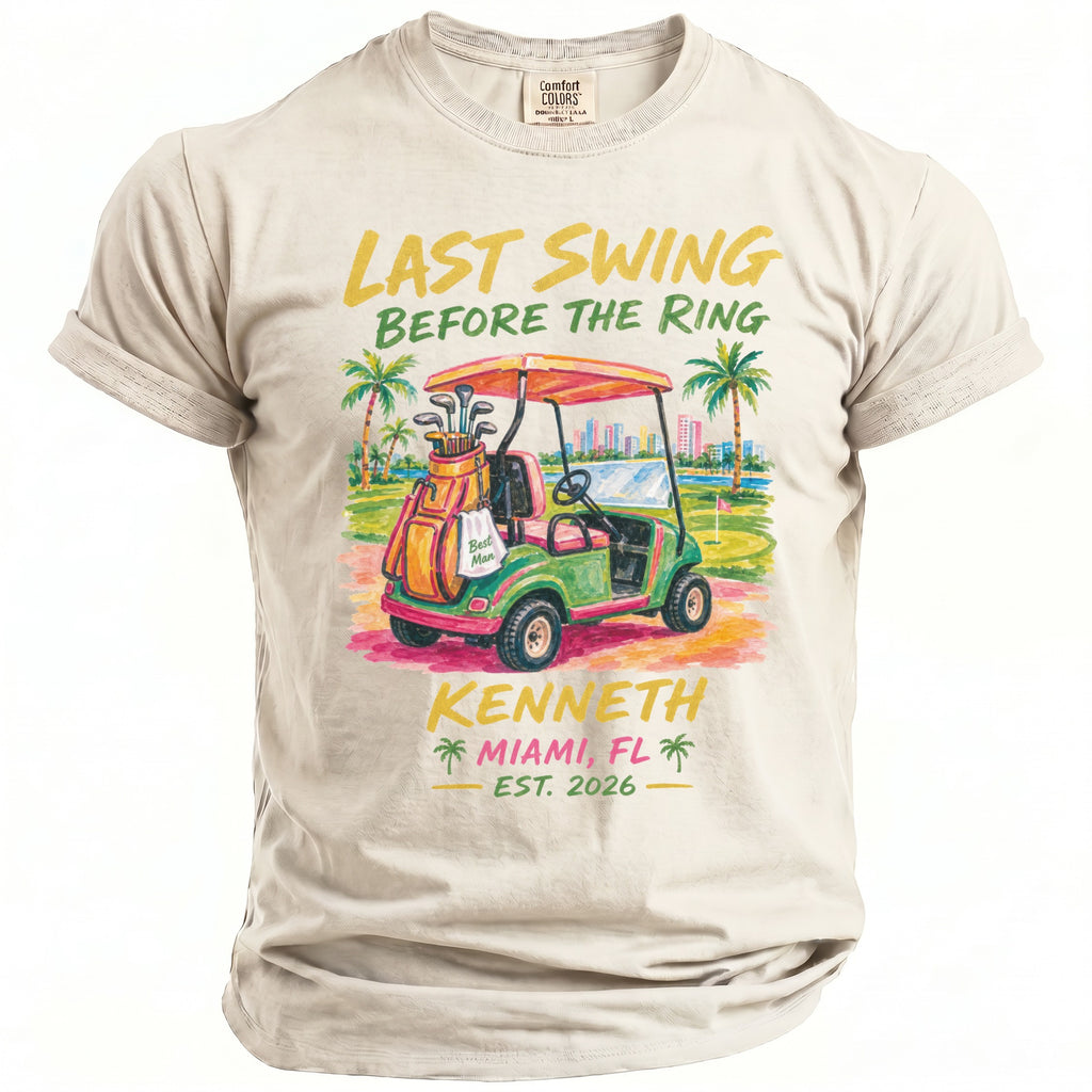 T-shirt graphic features golf cart, golf bag, and text "Last Swing Before the Ring Kenneth Miami FL Est. 2026".