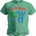 Green t-shirt with "Under New Management Mike's Bach" text and cartoon graphics.