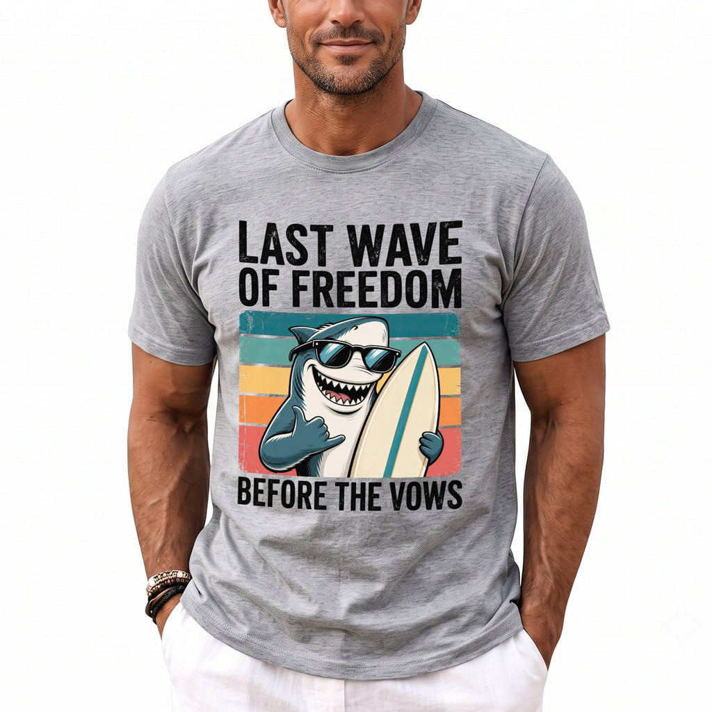 Grey t-shirt with "Last Wave of Freedom Before The Vows" text and surfing shark graphic.