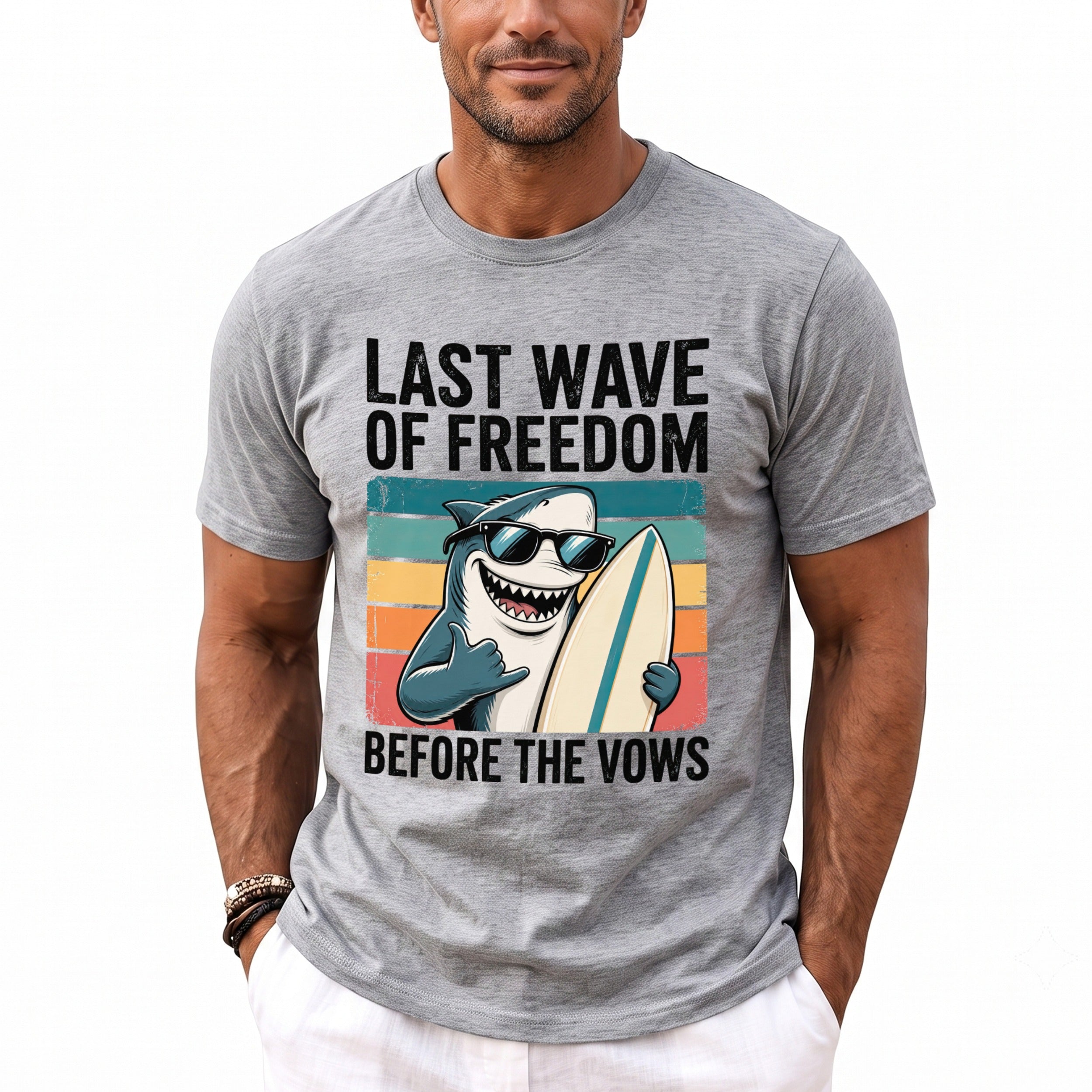 Grey t-shirt with "Last Wave of Freedom Before The Vows" text and surfing shark graphic.