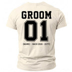 Back of cream t-shirt with black text "GROOM 01 [NAME] - BACH 2026 - [CITY]".