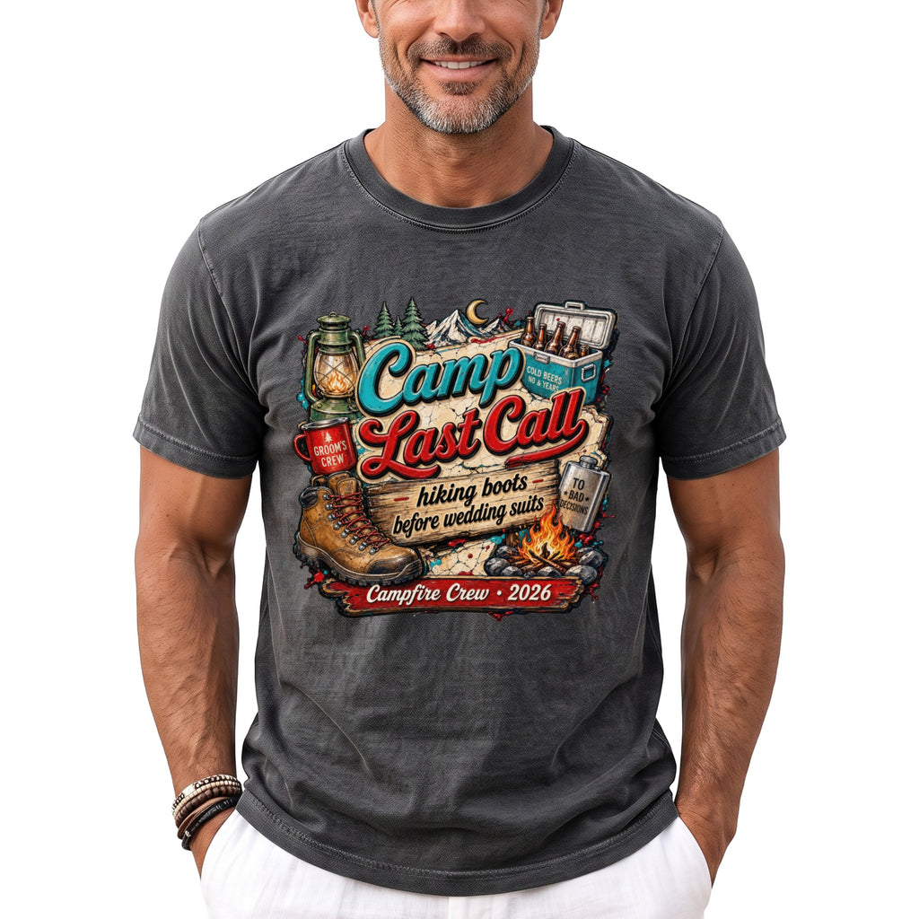 A man wearing a charcoal grey t-shirt featuring a colorful camping-themed graphic and text that reads Camp Last Call.