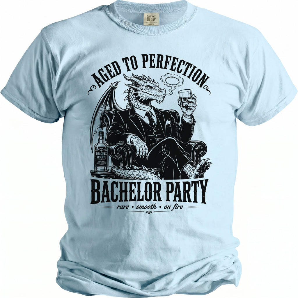 Light blue t-shirt with a dragon in a suit holding a whiskey glass, "Bachelor Party" text.