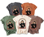T-shirts with a graphic of a man in a suit holding a cigar and drink.
