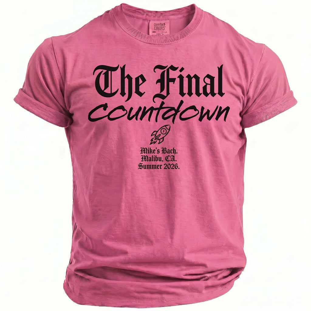 Pink t-shirt with black text "The Final Countdown", rocket graphic, and event details.