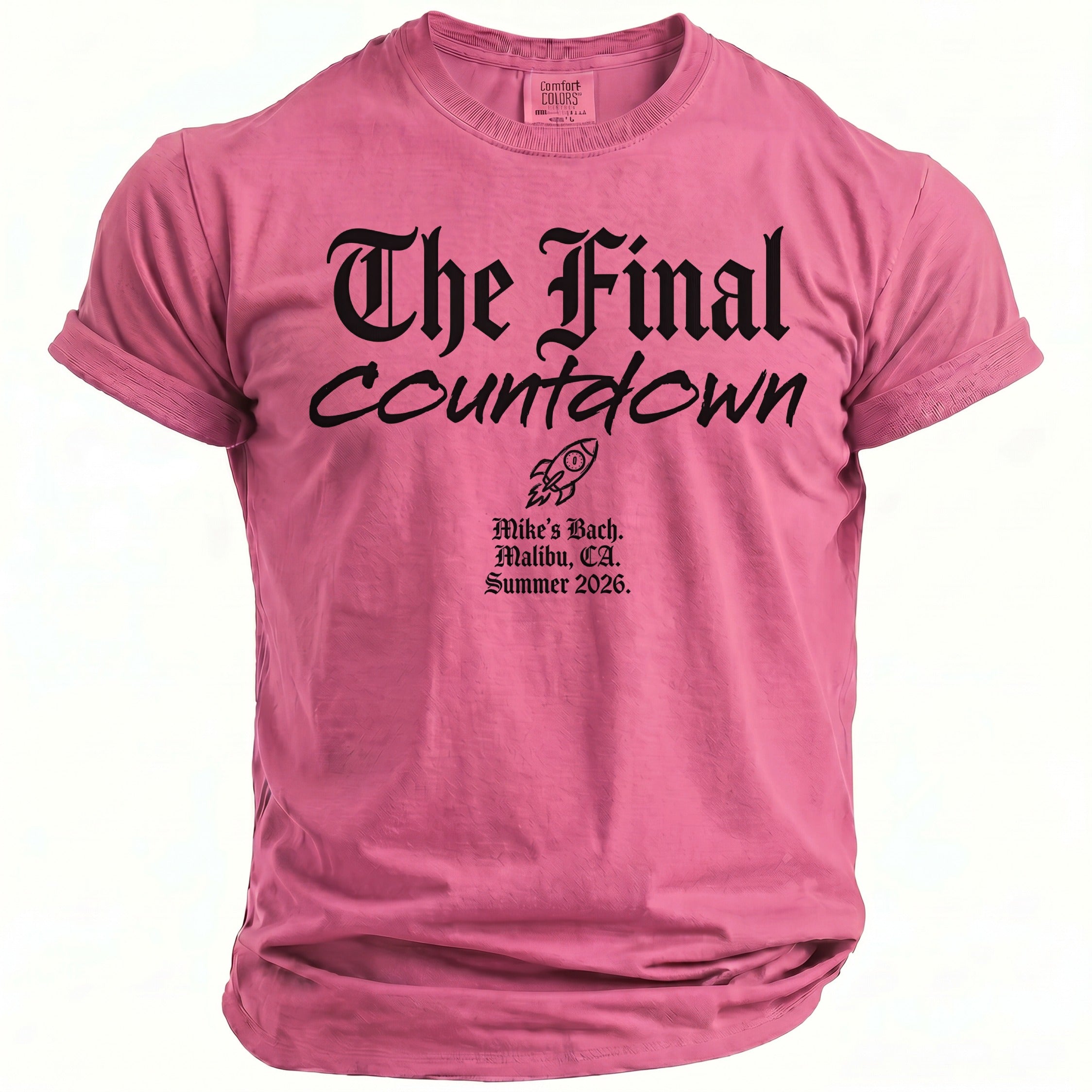 Pink t-shirt with black text "The Final Countdown", rocket graphic, and event details.