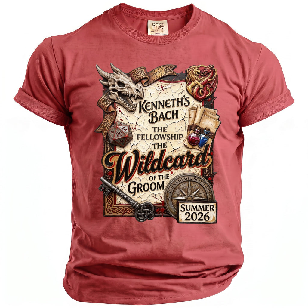 Red t-shirt with a graphic of a dragon, skull, D20 die, potions, and text "Kenneth's Bach The Fellowship The Wildcard of the Groom Edinburgh, Scotland Summer 2026".