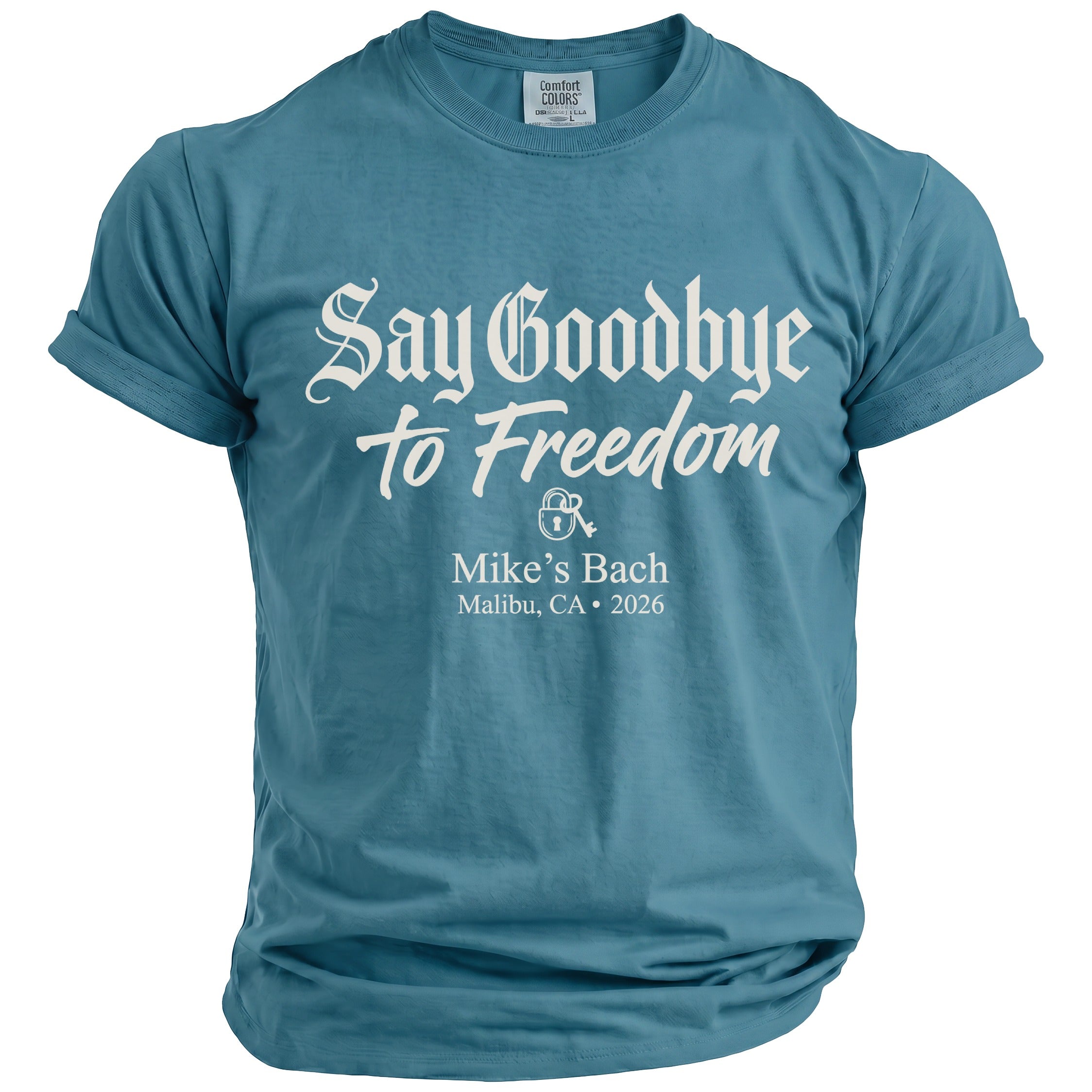 Blue t-shirt with white text: "Say Goodbye to Freedom," lock graphic, "Mike's Bach," and "Malibu, CA • 2026."