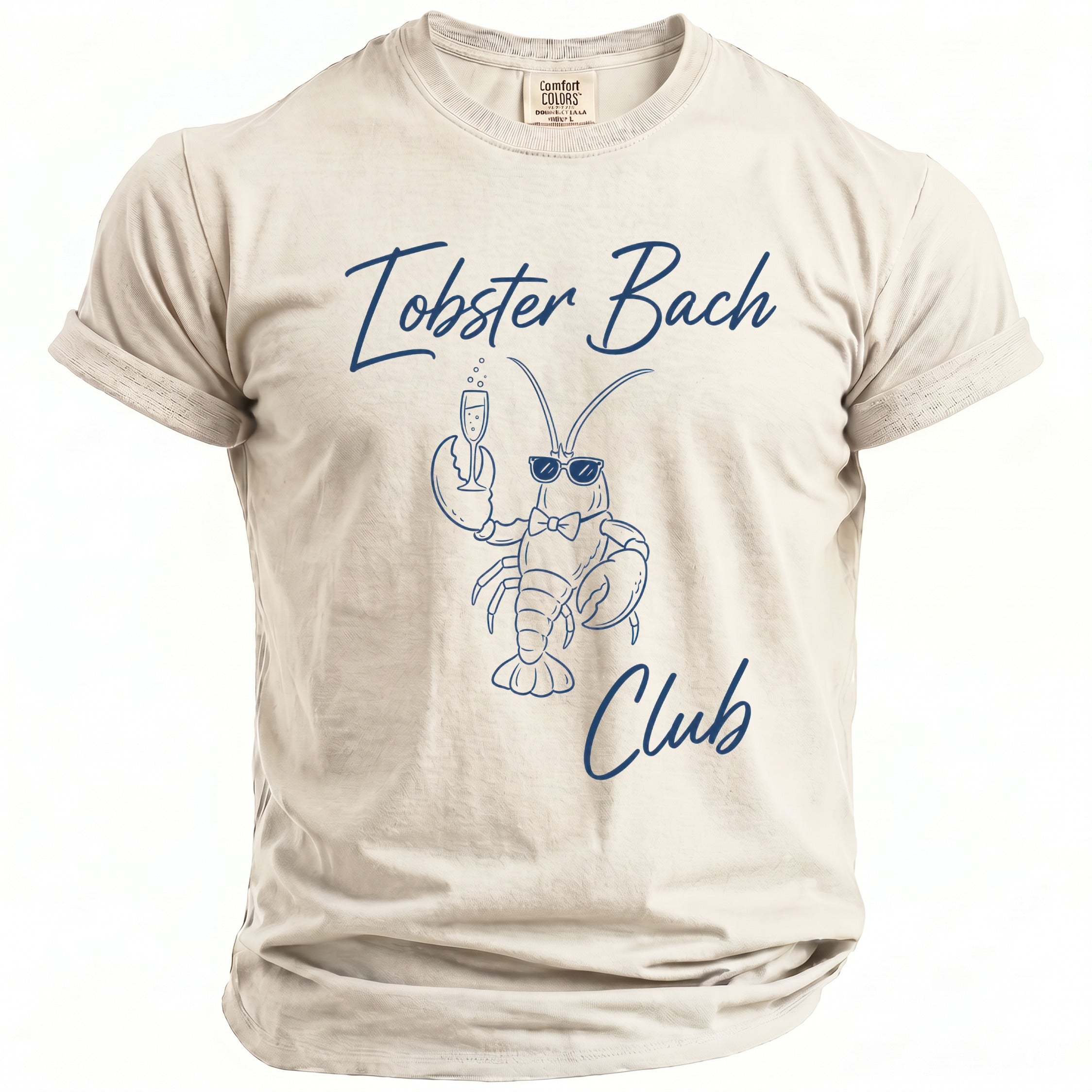 Light beige t-shirt with navy blue graphic of a lobster holding champagne and text "Lobster Bach Club".