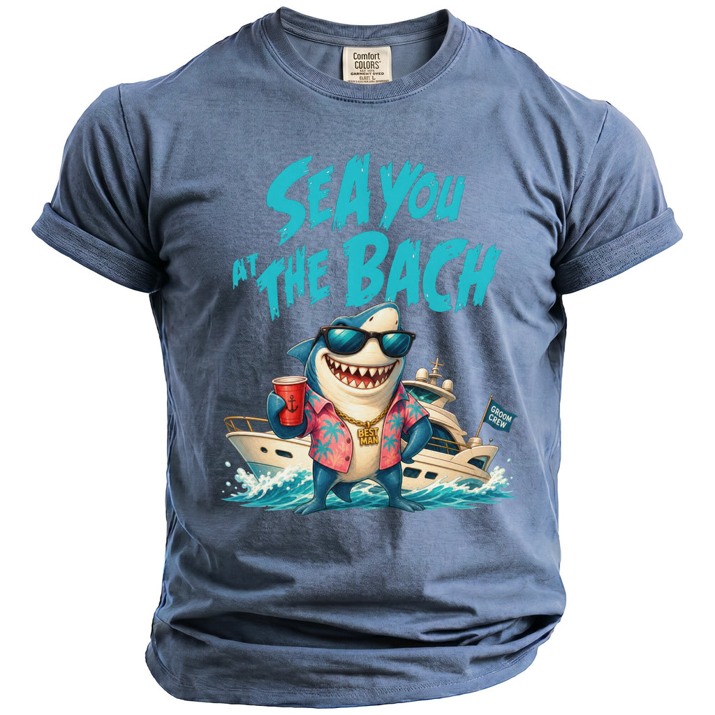 Blue t-shirt featuring a shark in sunglasses, a pink shirt, and a yacht graphic with text.