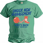 Green t-shirt with "UNDER NEW MANAGEMENT" and a ball and chain graphic.