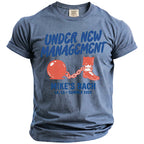 Blue t-shirt with "Under New Management" and ball and chain graphic.